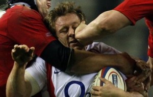 England's Wilkinson is tackled by Wales's Popham and Jones during Six Nations rugby union match at Twickenham in London
